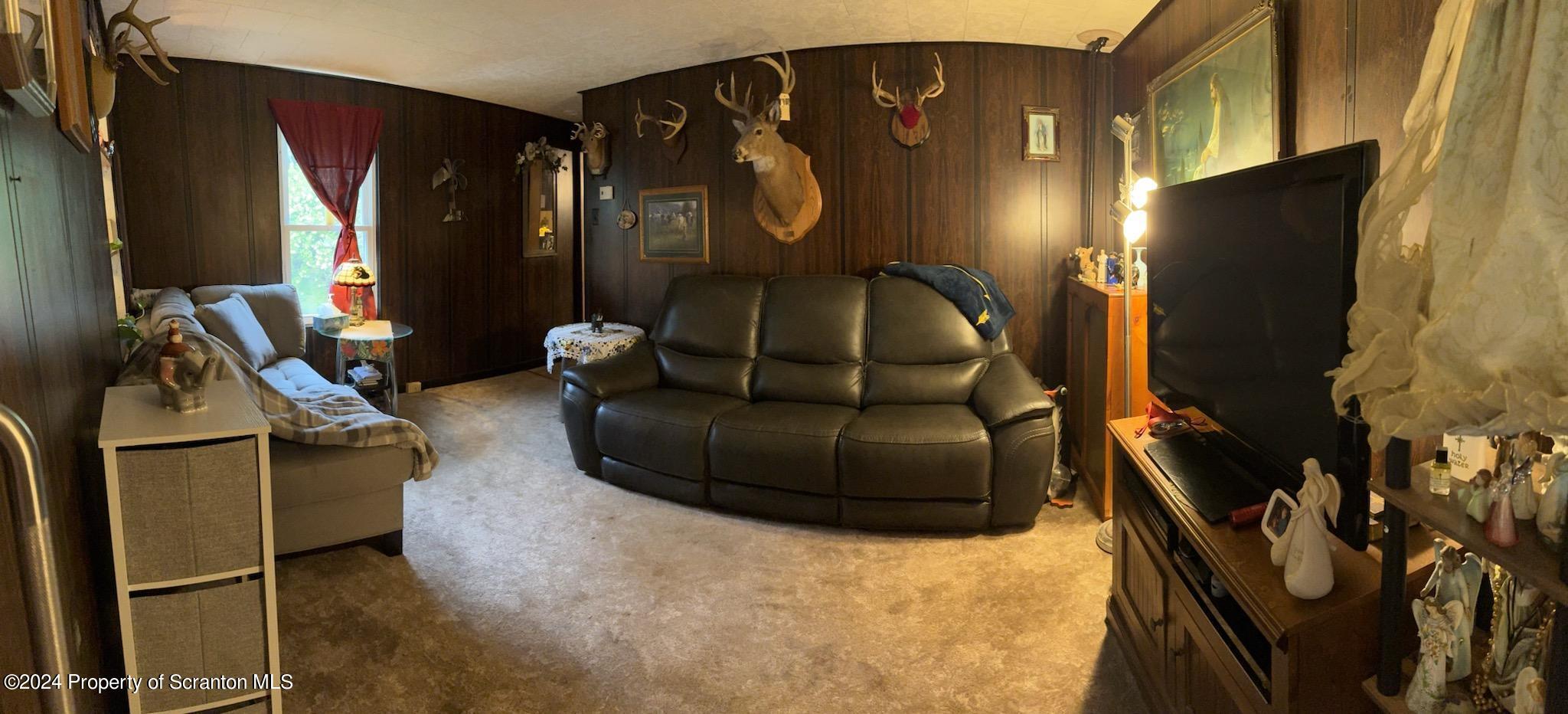 2 Sawmill Road Hunlock Creek, PA 18621 - Photo 8 of 22 a living room with furniture a flat screen tv and floor to ceiling window