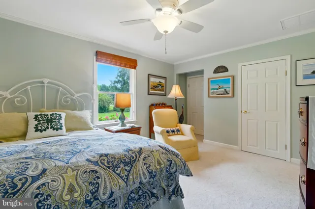 a bedroom with a bed couch and window