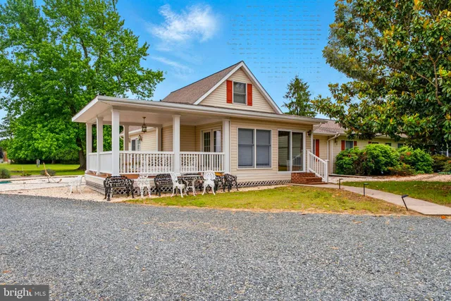 a view of a house with swimming pool and porch
