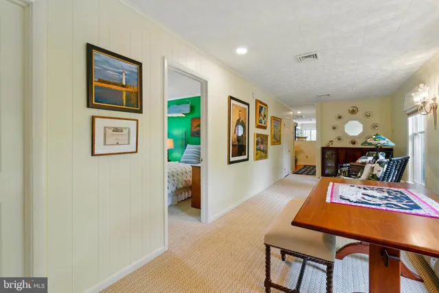 a living room with furniture and a dining table
