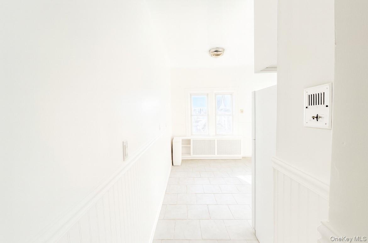 194 Summit Avenue, Unit 2 Mount Vernon, NY 10550 - Photo 5 of 19 Corridor with light tile patterned floors and radiator