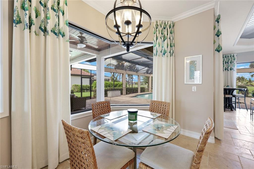 9856 Corso Bello Drive Naples, FL 34113 - Photo 11 of 50 a view of a dining room with furniture window and outside view