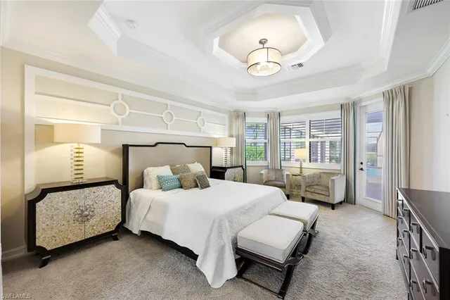 a bedroom with bed and a chandelier