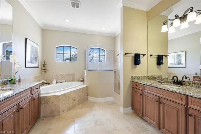 a spacious bathroom with a granite countertop sink and a mirror