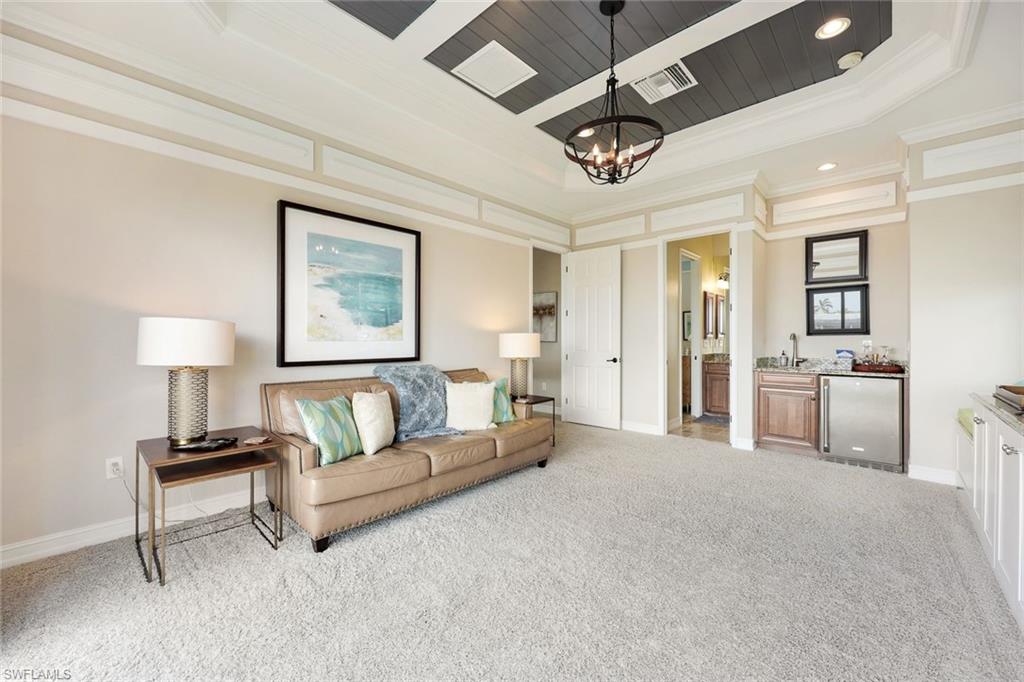 9856 Corso Bello Drive Naples, FL 34113 - Photo 17 of 50 a living room with furniture and a lamp