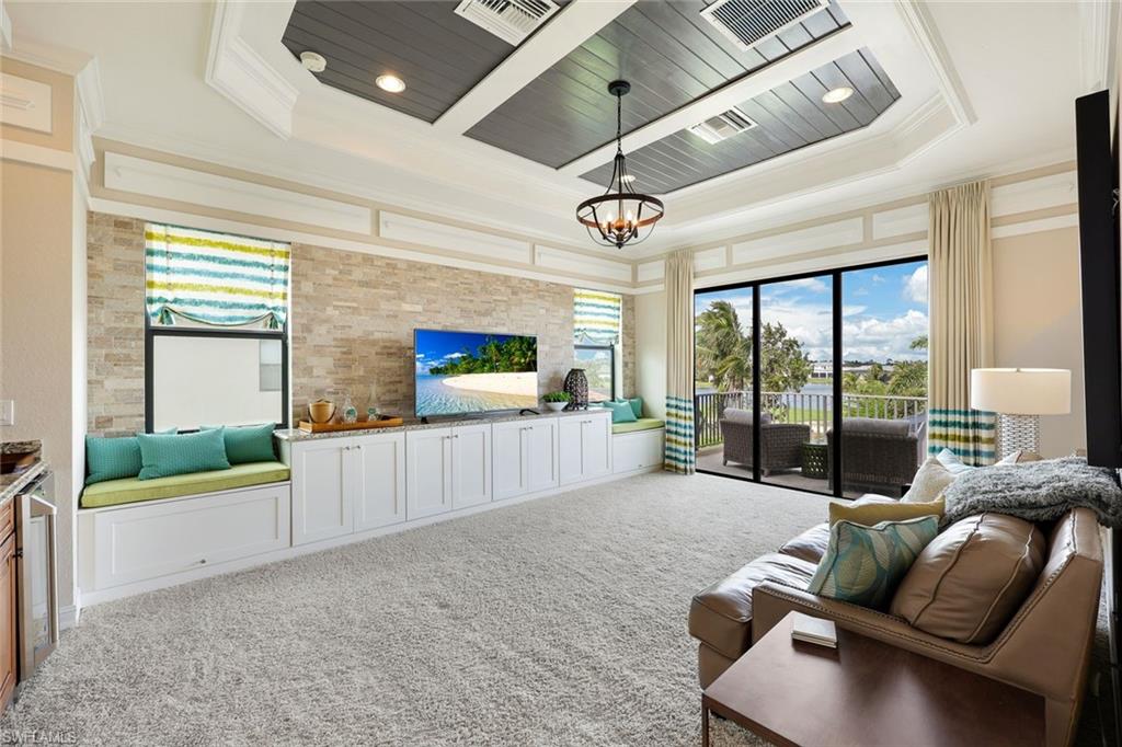 9856 Corso Bello Drive Naples, FL 34113 - Photo 18 of 50 a living room with furniture and a large window