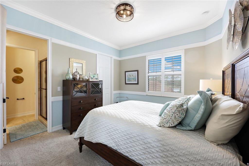 9856 Corso Bello Drive Naples, FL 34113 - Photo 21 of 50 a bedroom with a bed and a chandelier