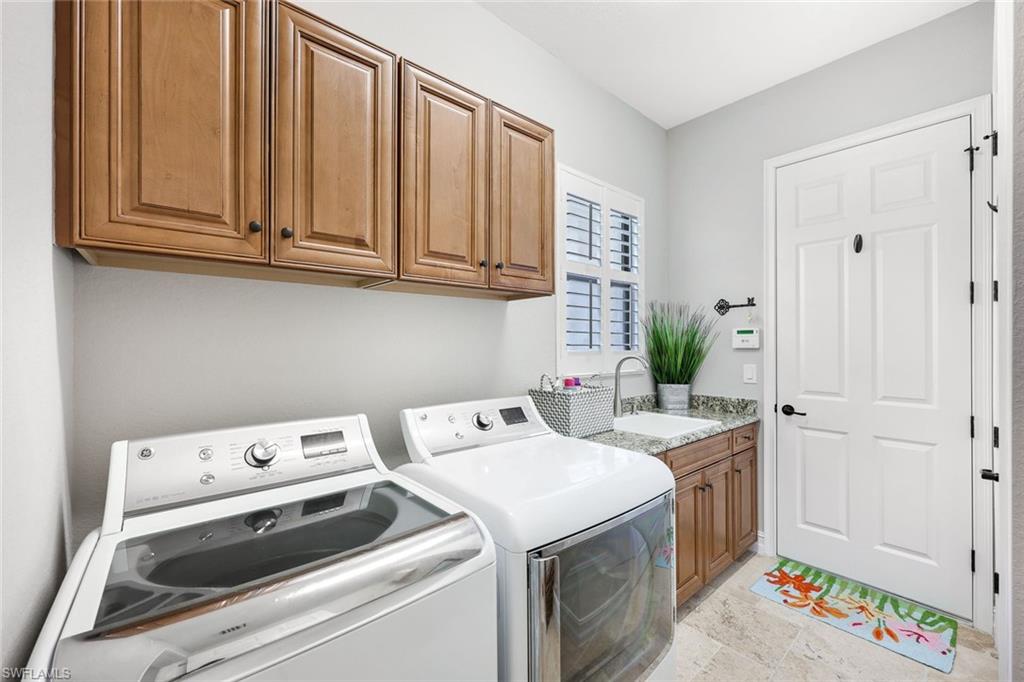9856 Corso Bello Drive Naples, FL 34113 - Photo 24 of 50 a utility room with dryer and washer