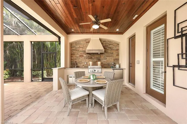 a dining room with furniture large windows and a chandelier