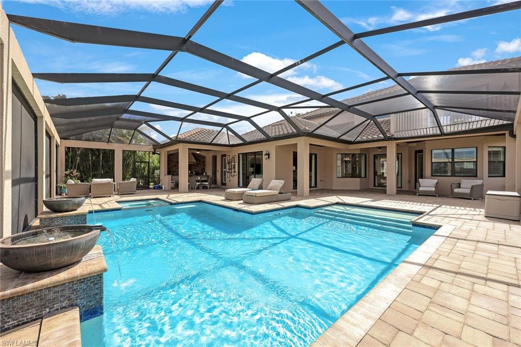 9856 Corso Bello Drive Naples, FL 34113 - Photo 27 of 50 a view of a swimming pool with a patio