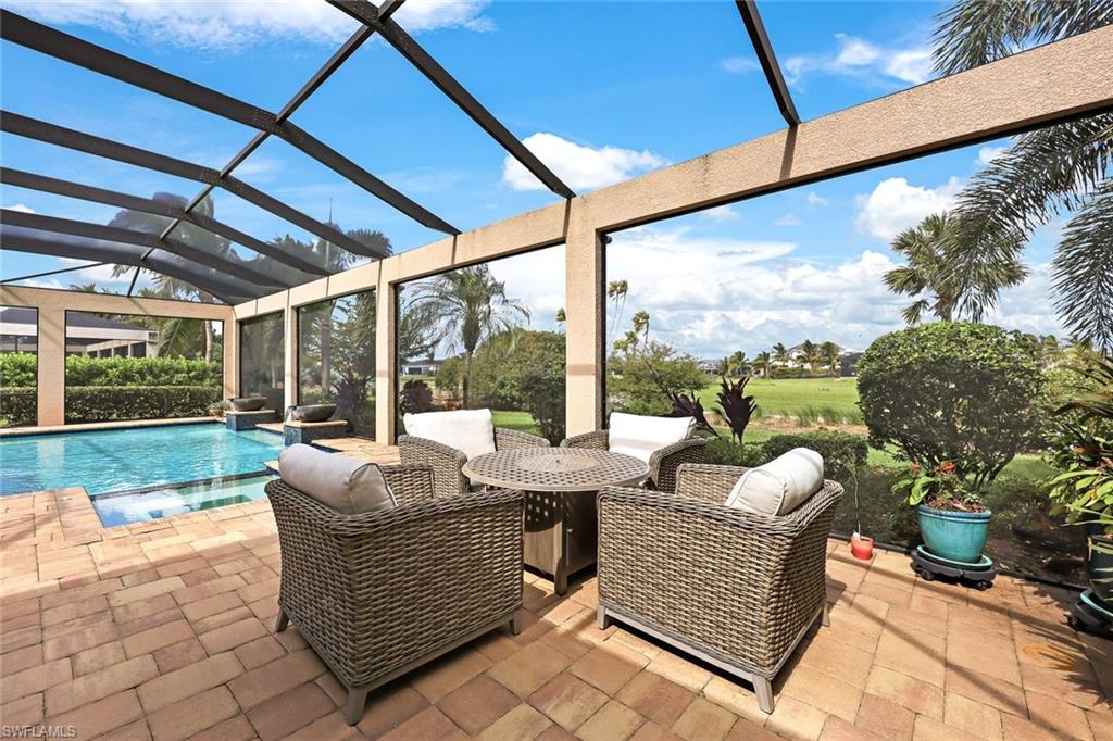 9856 Corso Bello Drive Naples, FL 34113 - Photo 29 of 50 a outdoor living space with furniture and garden view