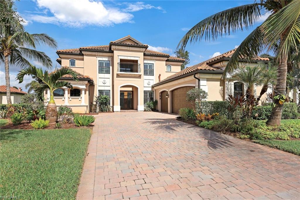 9856 Corso Bello Drive Naples, FL 34113 - Photo 3 of 50 a front view of a house with a garden
