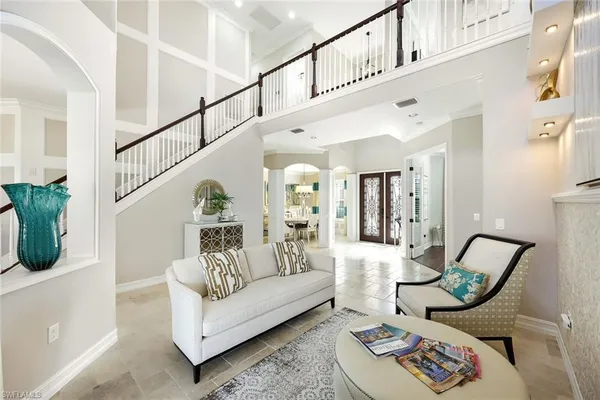 a living room with furniture and a chandelier