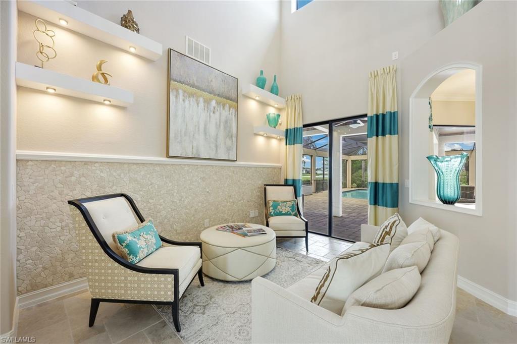 9856 Corso Bello Drive Naples, FL 34113 - Photo 5 of 50 a living room with furniture and a potted plant