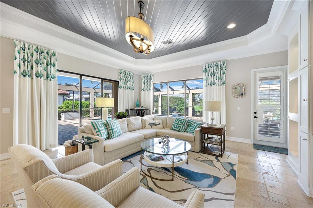 9856 Corso Bello Drive Naples, FL 34113 - Photo 8 of 50 a living room with furniture and a large window