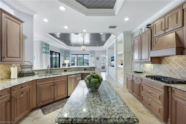 a large kitchen with stainless steel appliances granite countertop a lot of counter space
