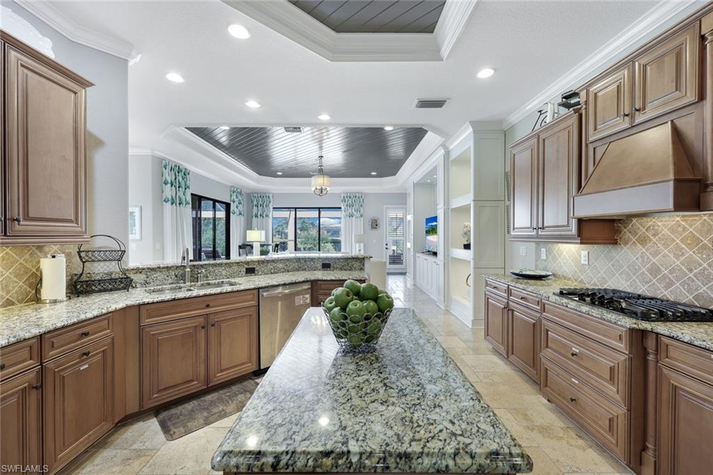 9856 Corso Bello Drive Naples, FL 34113 - Photo 10 of 50 a large kitchen with stainless steel appliances granite countertop a lot of counter space
