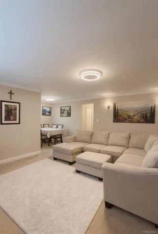 a living room with couches and a night stand