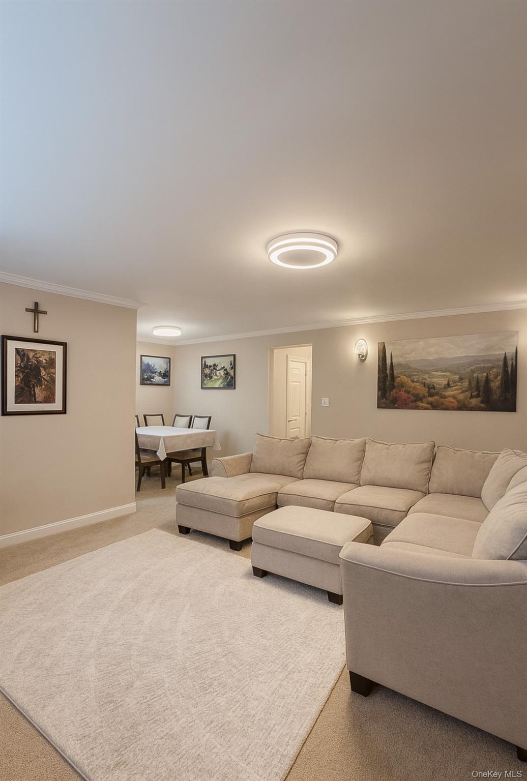 a living room with couches and a night stand