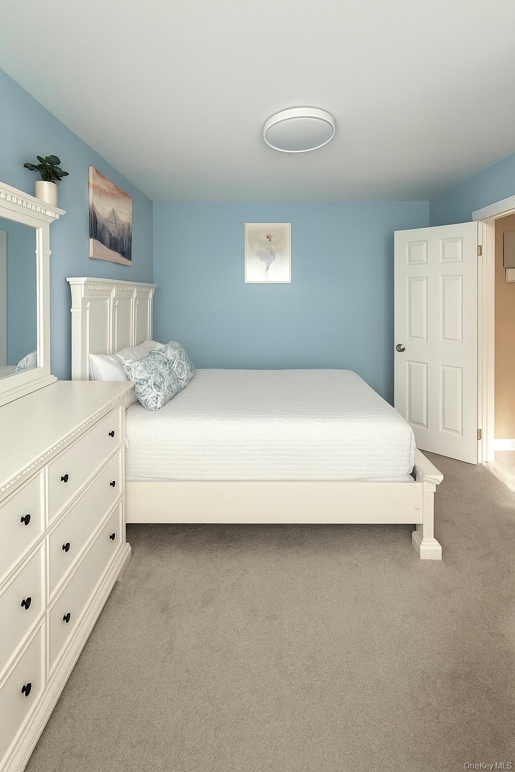 150-40 Jewel Avenue, Unit 66B Queens, NY 11367 - Photo 8 of 11 a large bed sitting in a bedroom next to a cabinet