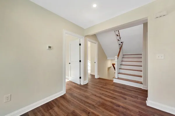 a view of a room with wooden floor and window