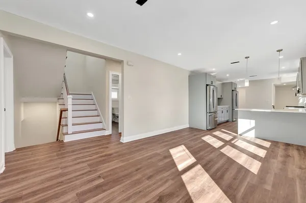 a view of an empty room with wooden floor