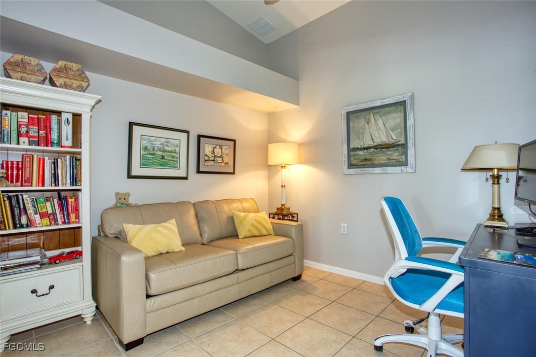 10371 McArthur Palms Lane, Unit 2823 Fort Myers, FL 33966 - Photo 15 of 48 a living room with furniture and a book shelf