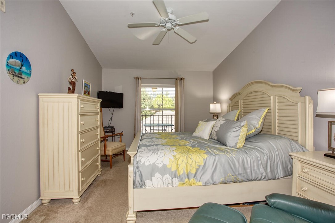 10371 McArthur Palms Lane, Unit 2823 Fort Myers, FL 33966 - Photo 16 of 48 a bedroom with a bed and a chandelier