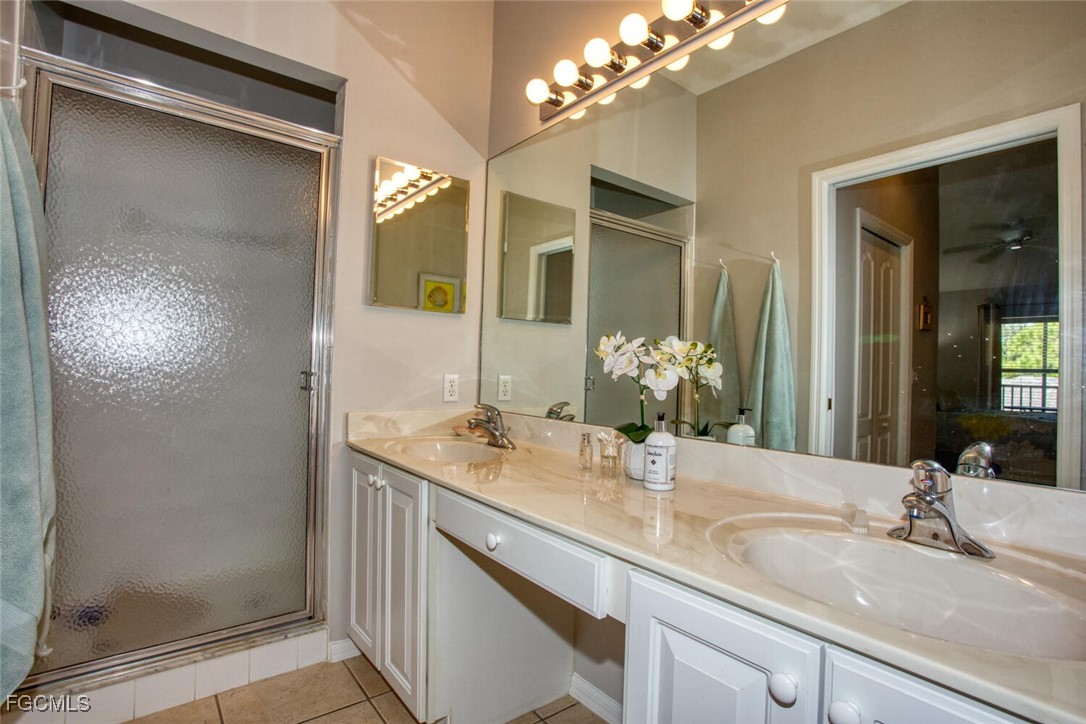 10371 McArthur Palms Lane, Unit 2823 Fort Myers, FL 33966 - Photo 18 of 48 a bathroom with a granite countertop sink and a mirror