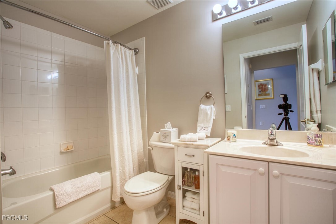 10371 McArthur Palms Lane, Unit 2823 Fort Myers, FL 33966 - Photo 20 of 48 a bathroom with a sink toilet and shower