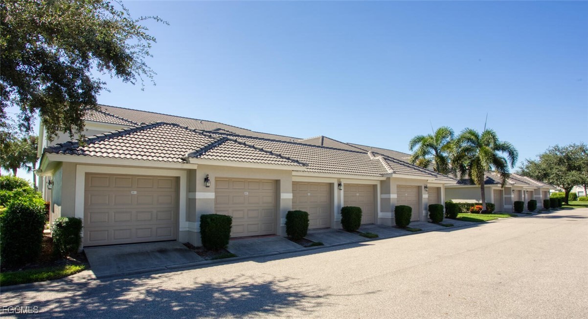 10371 McArthur Palms Lane, Unit 2823 Fort Myers, FL 33966 - Photo 22 of 48 a front view of a house with a garden