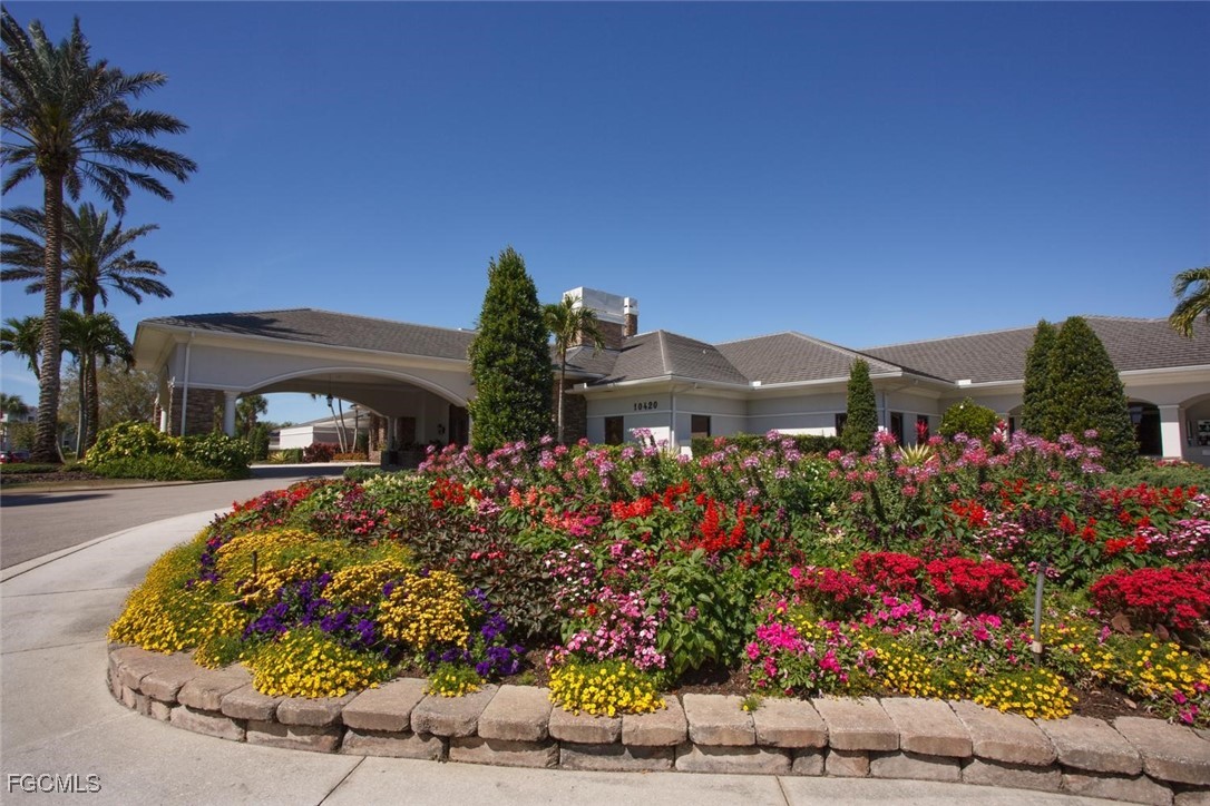 10371 McArthur Palms Lane, Unit 2823 Fort Myers, FL 33966 - Photo 30 of 48 front view of a house with a yard
