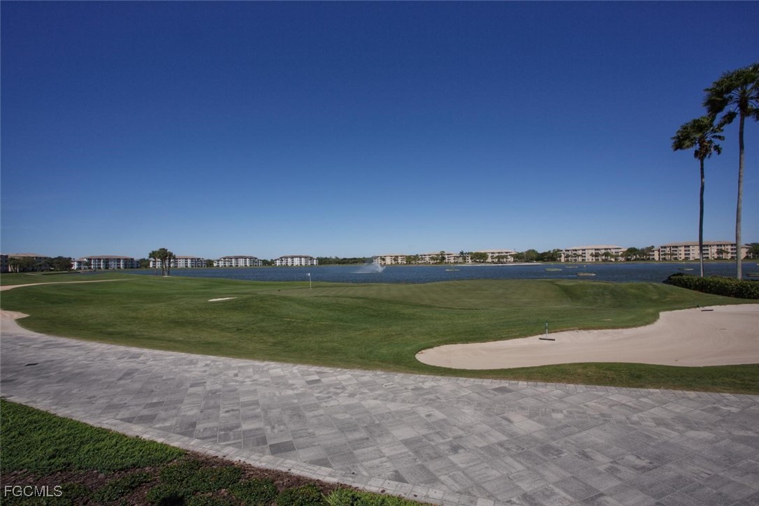10371 McArthur Palms Lane, Unit 2823 Fort Myers, FL 33966 - Photo 35 of 48 a view of a lake with houses in the background