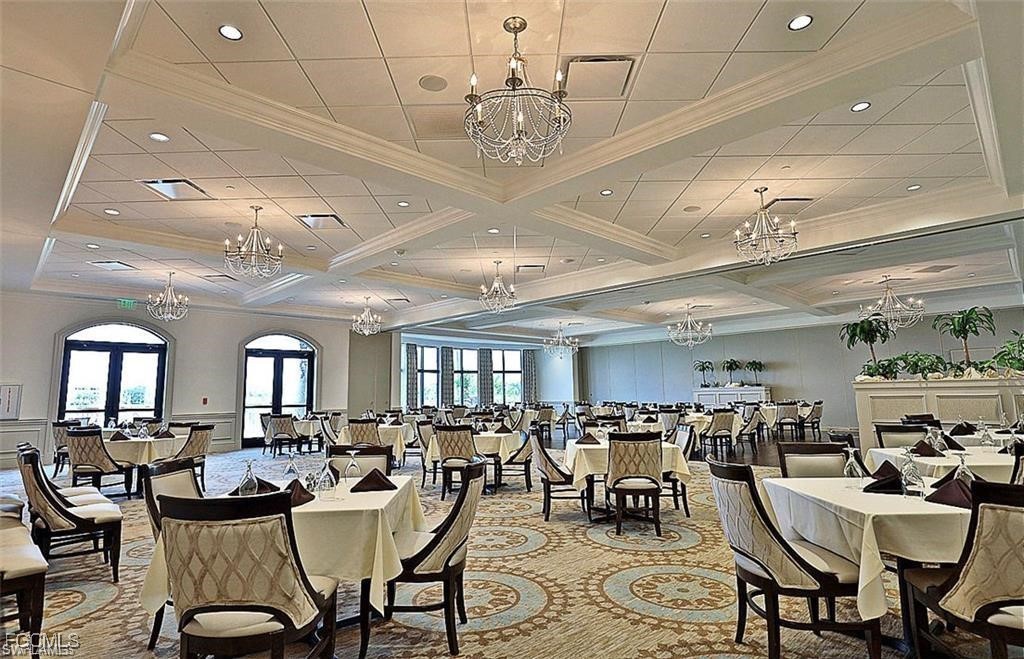 10371 McArthur Palms Lane, Unit 2823 Fort Myers, FL 33966 - Photo 40 of 48 a view of a dining room with furniture and a chandelier