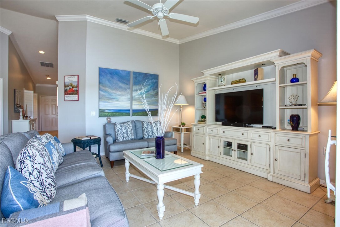 10371 McArthur Palms Lane, Unit 2823 Fort Myers, FL 33966 - Photo 5 of 48 a living room with furniture and a flat screen tv