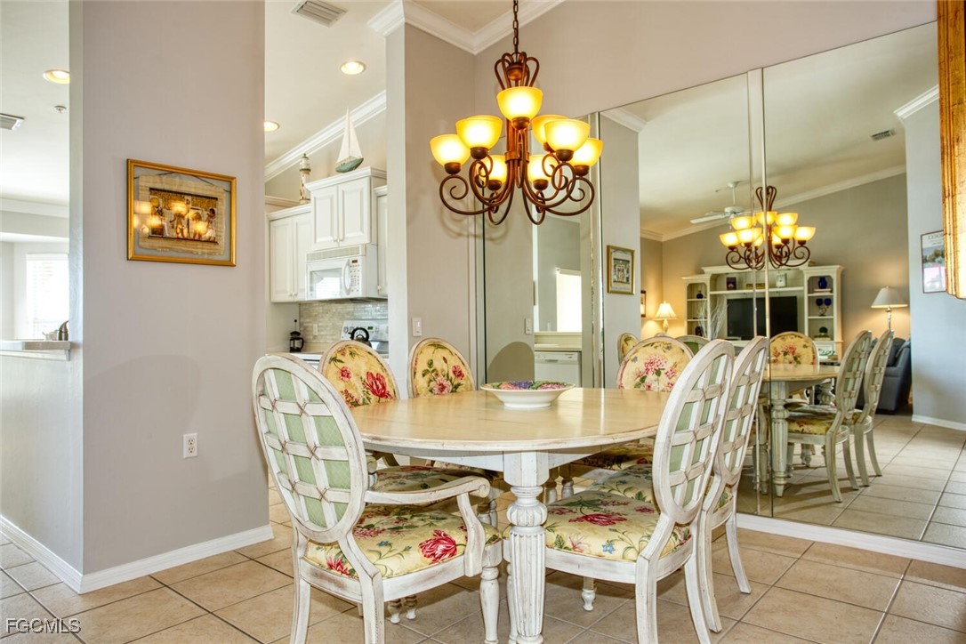 10371 McArthur Palms Lane, Unit 2823 Fort Myers, FL 33966 - Photo 7 of 48 a view of a dining room with furniture and chandelier