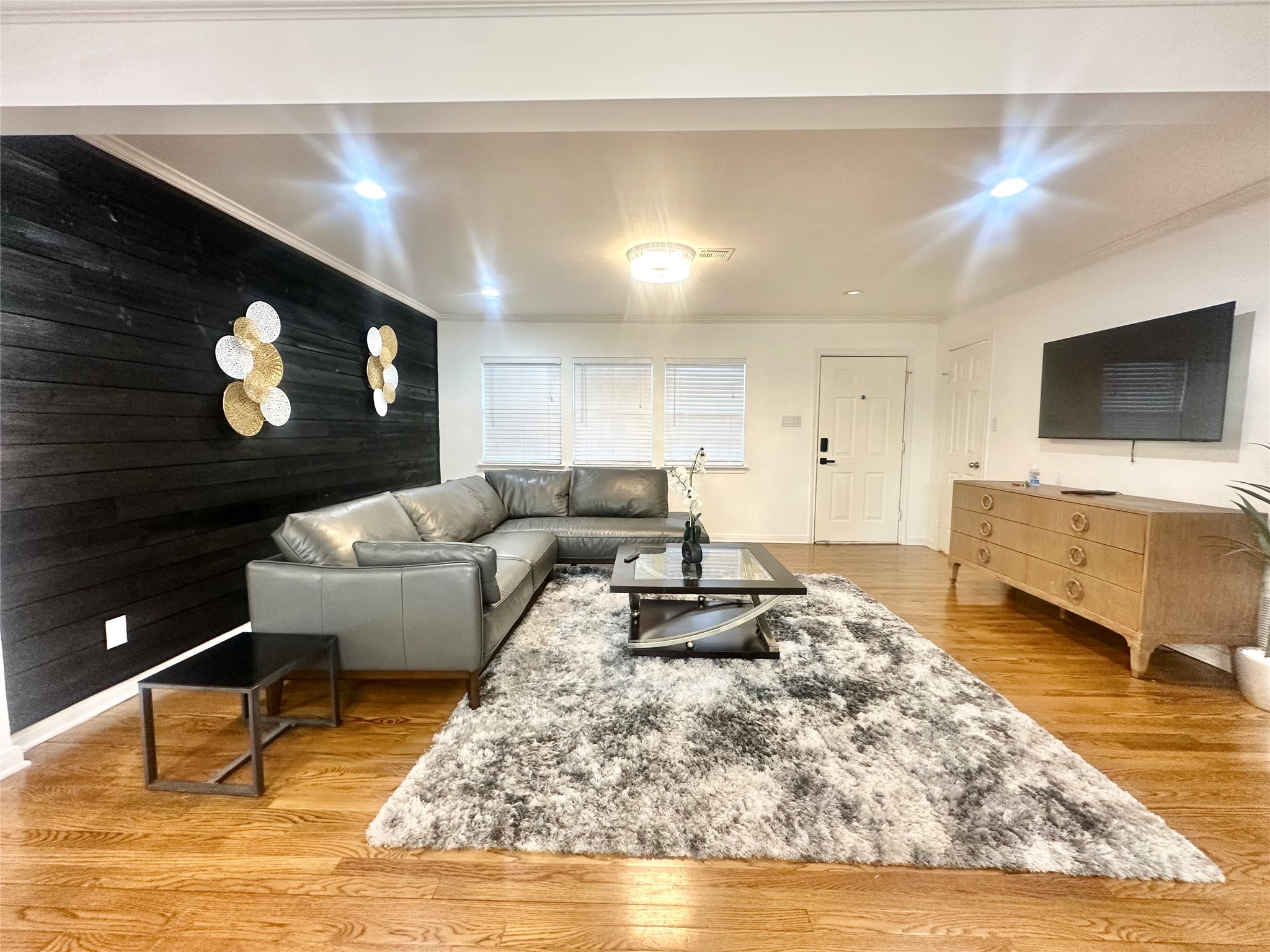 a living room with furniture and a flat screen tv