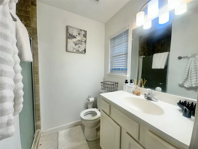 a bathroom with a sink toilet and mirror
