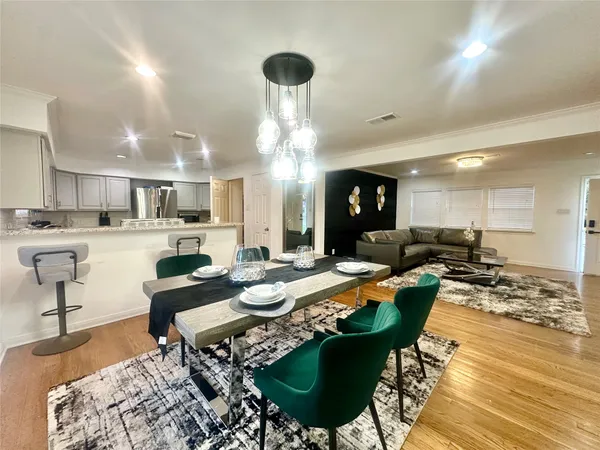 a living room with lots of furniture and kitchen view