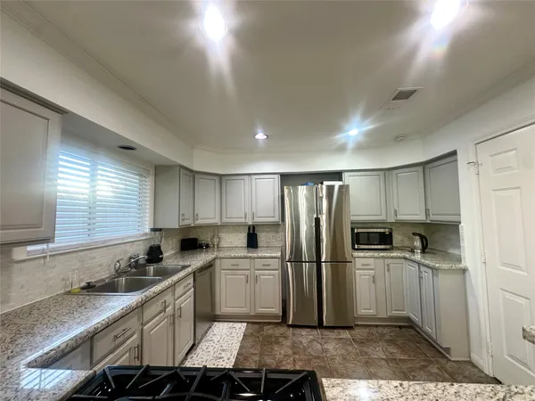 a kitchen with refrigerator cabinets and a counter top space