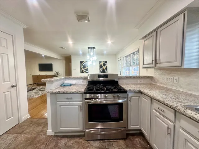 a kitchen with stainless steel appliances granite countertop a stove and a sink