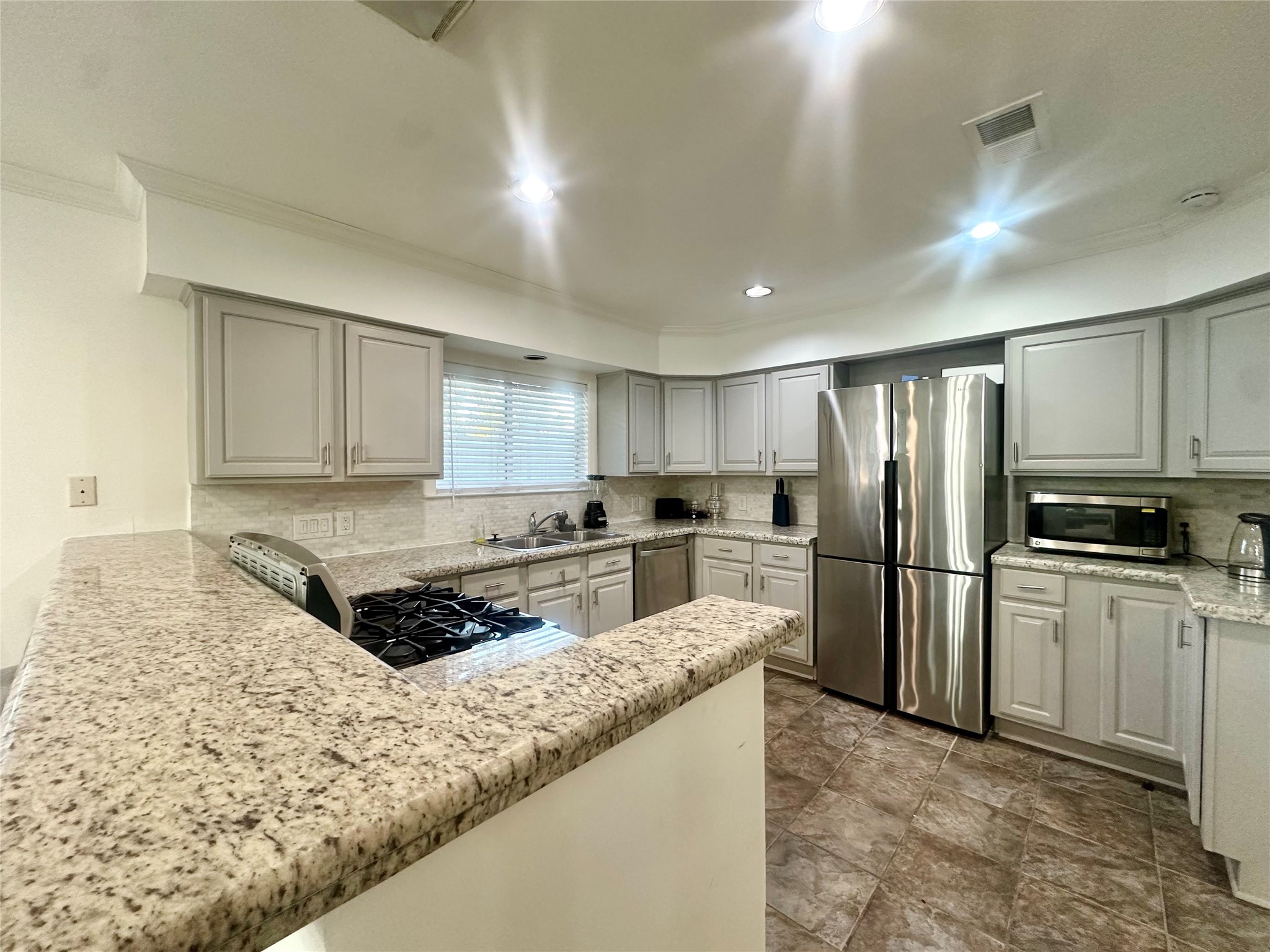 5329 Pagewood Lane Houston, TX 77056 - Photo 9 of 18 a kitchen with stainless steel appliances granite countertop a refrigerator a stove and a sink