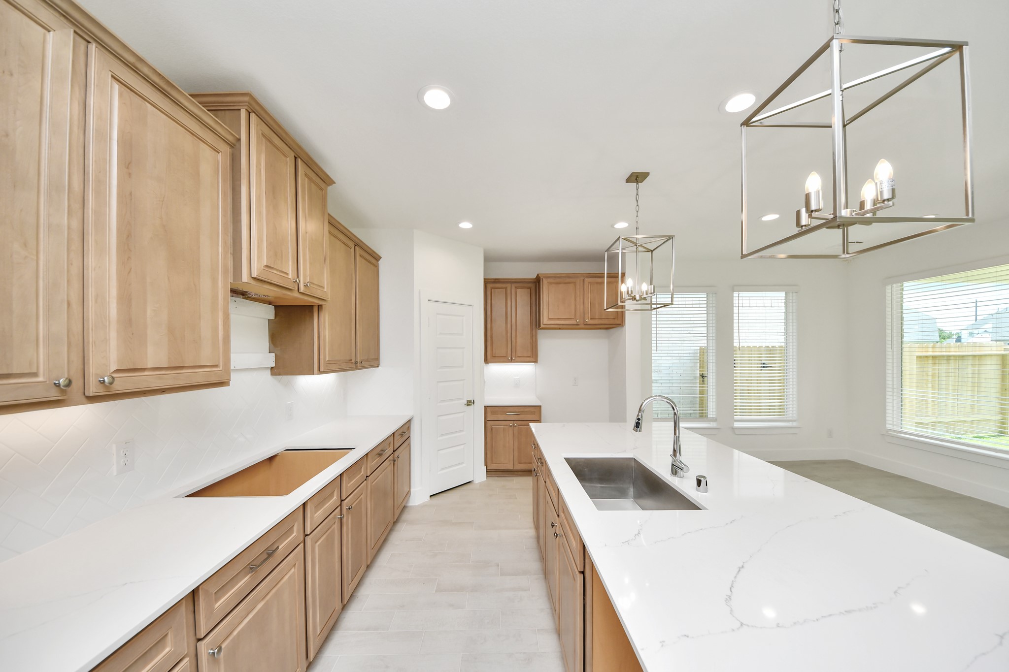 3102 Native Spg Drive Spring, TX 77373 - Photo 11 of 47 This generously spacious kitchen is a dream realized! With a massive granite island, high ceilings, soft close cabinets, granite countertops, stainless steel appliances, a sleek tile backsplash, recessed lighting, and an extended counter area, it offers both style and practicality. All this opens up to the expansive family room, creating a perfect hub for gatherings.