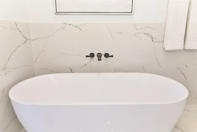 a white bath tub sitting in a bathroom