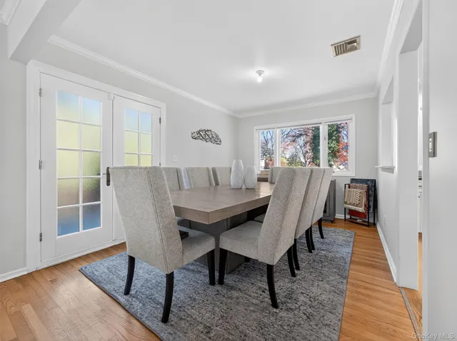a dining room with furniture and wooden floor