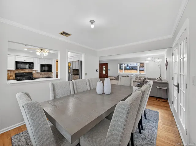 a spacious bathroom with a granite countertop sink a mirror and a bathtub