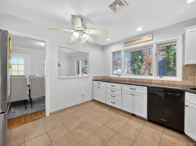 a kitchen with granite countertop a stove sink and microwave