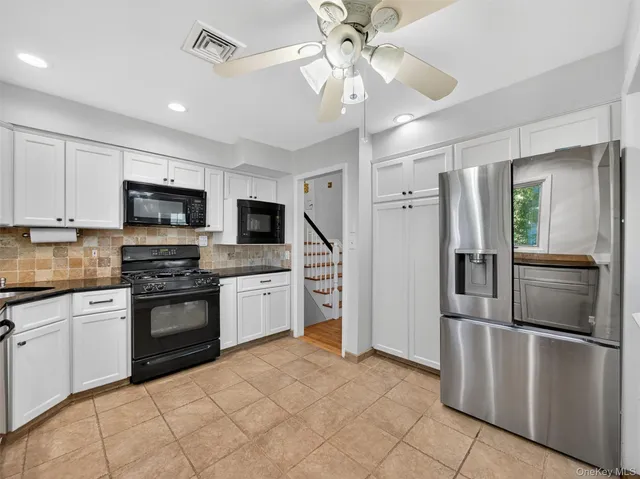 a view of a kitchen with a sink and a refrigerator