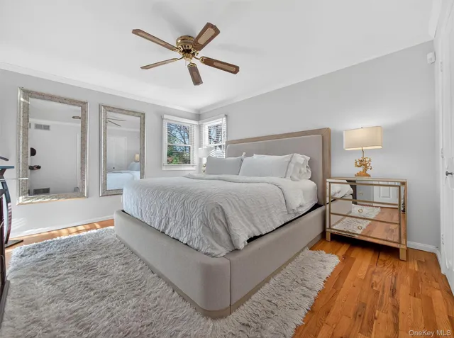 a bathroom with a granite countertop toilet sink and mirror