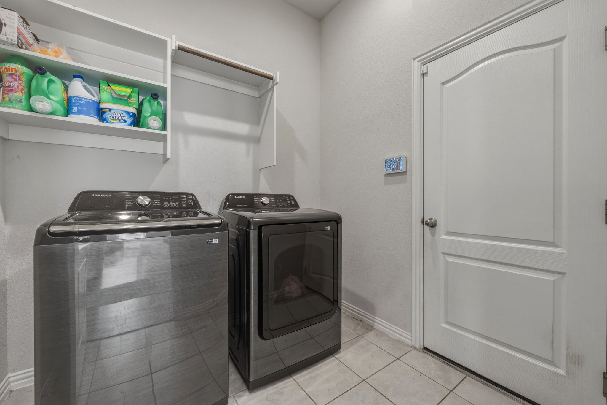 918 Leadtree Loop Buda, TX 78610 - Photo 18 of 27 Laundry area featuring washing machine and clothes dryer and light tile patterned flooring
